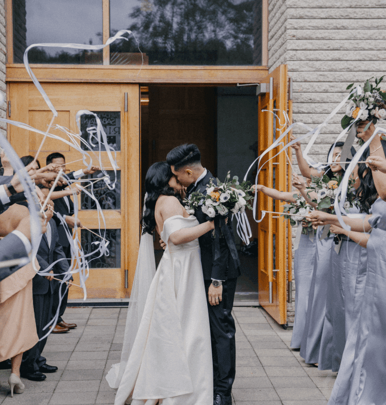 two persons kissing in front of crowd