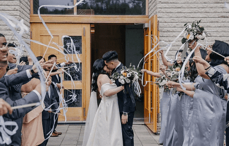 two persons kissing in front of crowd